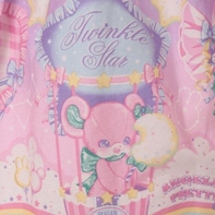 close up on a detail from Angelic Pretty print Cotton Candy Shop, showing a pink mouse in a hot air balloon, holding cotton candy shaped like a crescent moon.